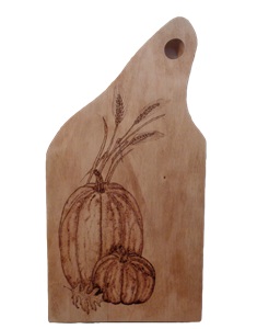 Pumpkins and wheat wood burned on maple wood