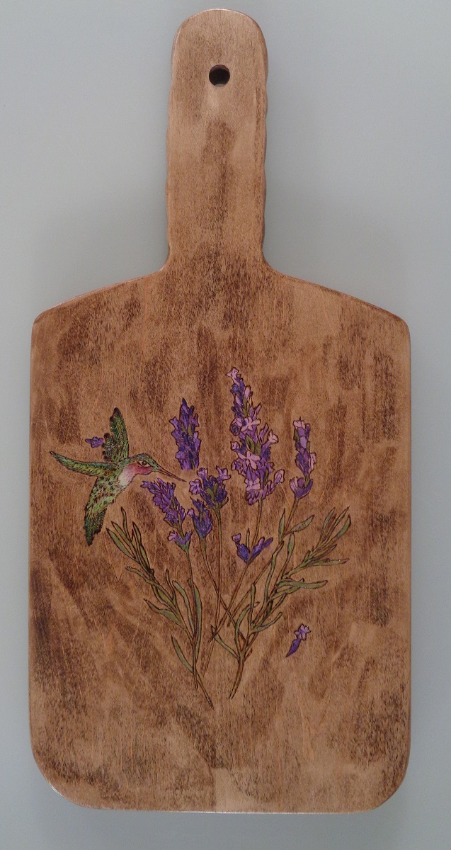 charcuterie board with woodburned hummingbird and lavendar