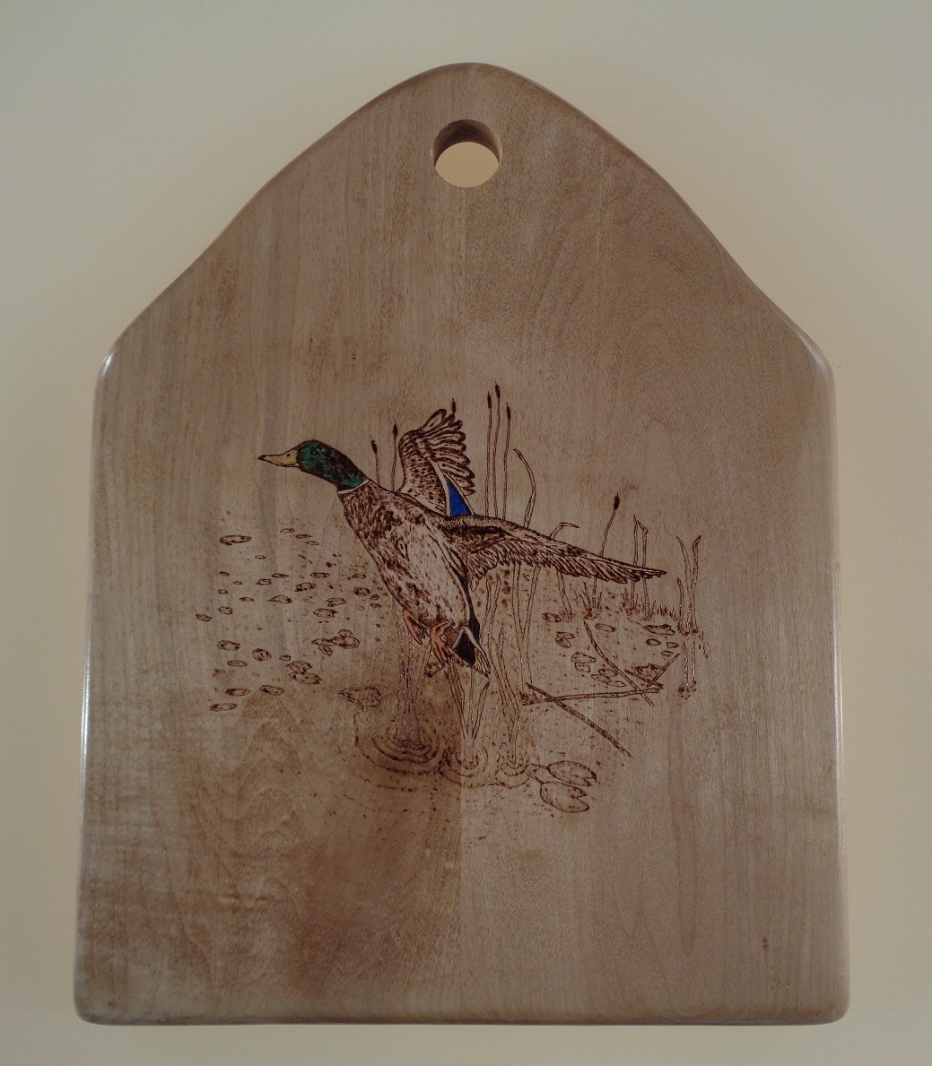 charcuterie board with woodburned hummingbird and lavendar