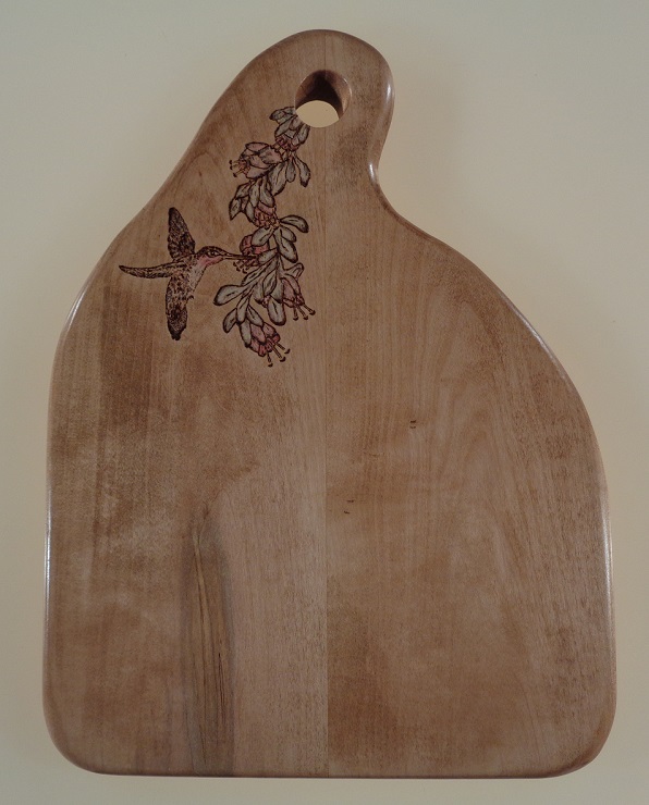 Woodburned hummingbird and flower on a maple charcuterie board