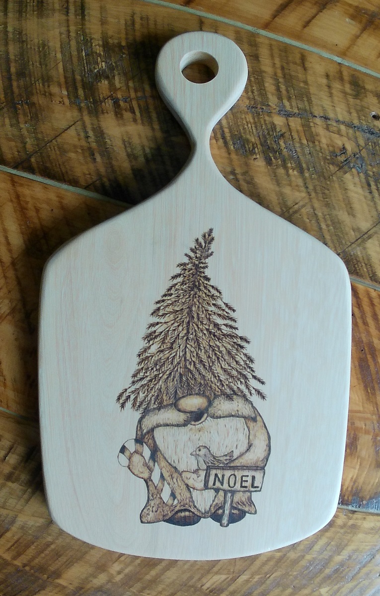 charcuterie board with woodburned gome, christmas tree and noel sign
