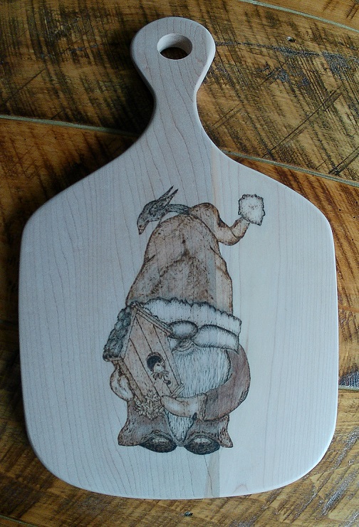 charcuterie board with woodburned gnome and birdhouse