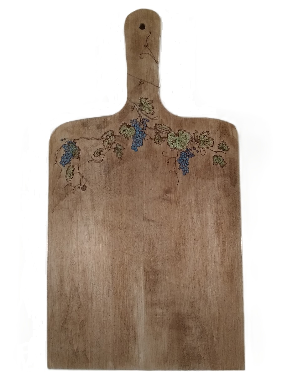 Grapes, vine and leaves wood burned on a maple board