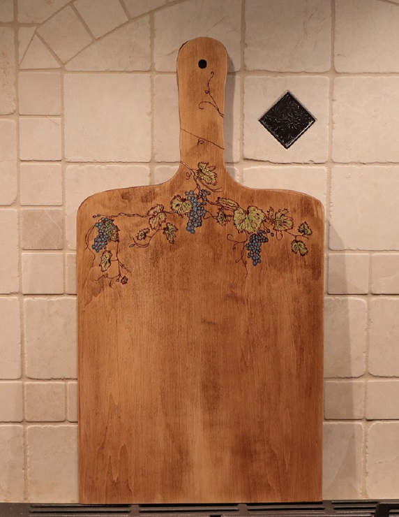 Grapevine and leaves woodburned into a maple charcuterie board