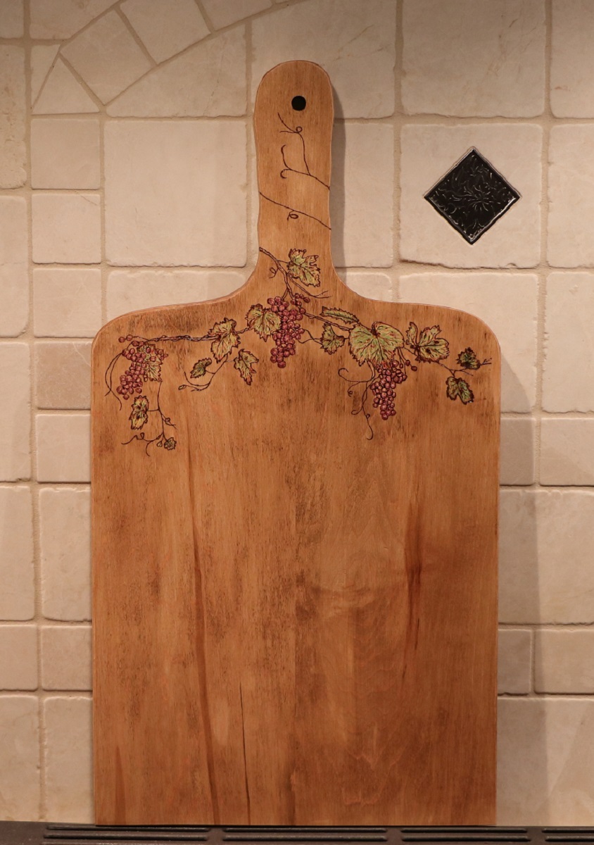 Grapevine and leaves woodburned into a maple charcuterie board