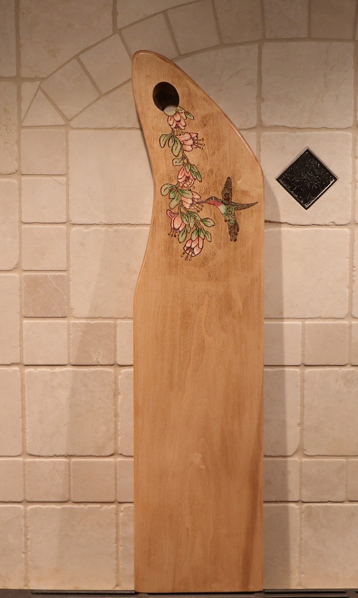 Hummngbird and flower woodburned into a maple charcuterie board